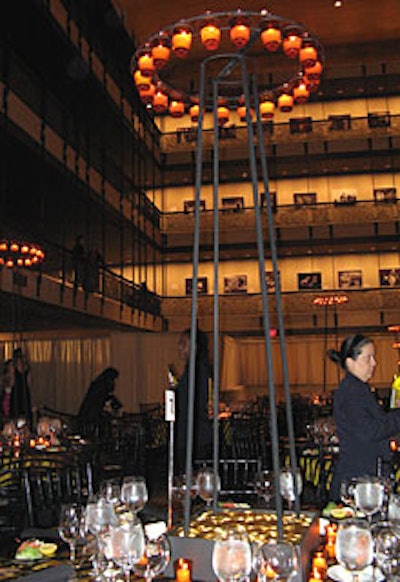 Some centerpieces featured a pile of gold topped with candleholders ranging from four to six feet high, which supported a ring of gold votives.