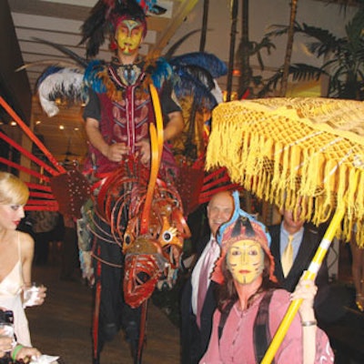 The entertainment included stilt walkers as costumed riders atop large mechanized birds accompanied by guides.
