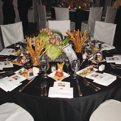 Tabletops and chairs at the dinner gala were a contrast in black and white. Bill Blass perfume was at alternating place settings.