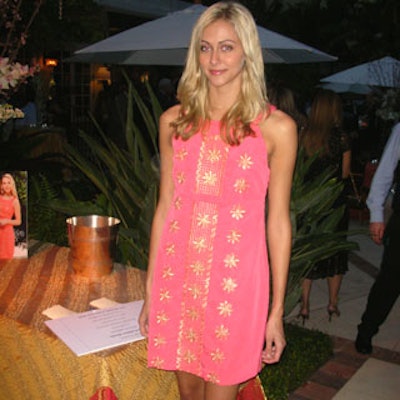 To benefit the Society of the Four Arts, guests bid on an original pink and gold Lilly Pulitzer cocktail dress, modeled at the event by Amanda Hearst.