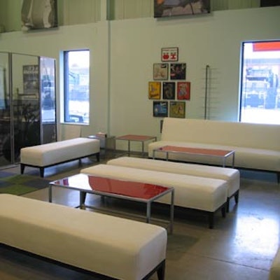 A lounge with sleek white couches and red accents dotted the main entrance.