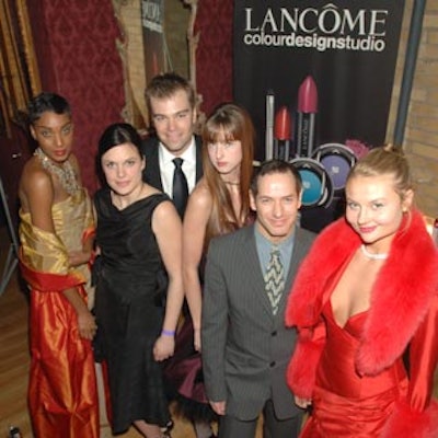 Models from NAM posed with guests in front of a Lanc?me Paris poster.