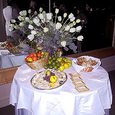 Astra put out white tulips, lemons, limes, peaches, oranges and a plate of various cheeses for the cocktail party.