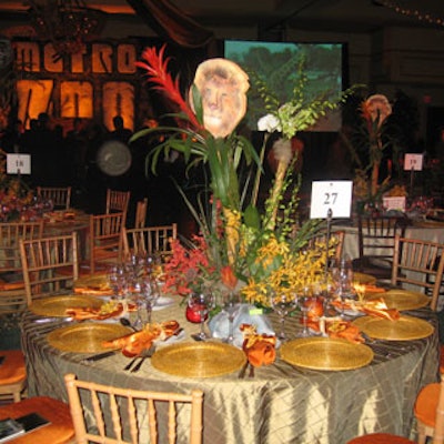The tables were covered in a satin-like fabric and featured centerpieces of vanda orchids, driftwood, and bromeliads topped with whimsical animal heads made of foam.