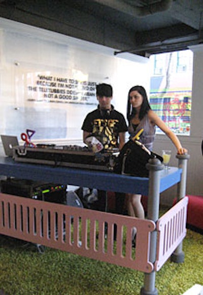 Hipsters-for-hire the MisShapes spun music from behind a colorful, kiddielike DJ booth. Teletubbyland served as the inspiration for the look of the booth and the area surrounding it, including a pink fence (made from MDA foam) and green AstroTurf.