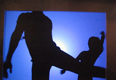 Throughout the evening, guests flocked to a 7- by 9-foot blue projection screen to watch the shadows of two dancers.