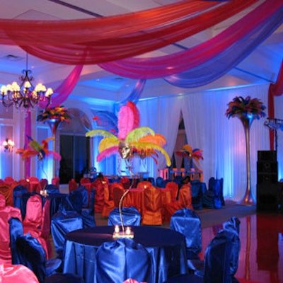 The ballroom featured many vibrant colors, interesting centerpieces, and a stage.