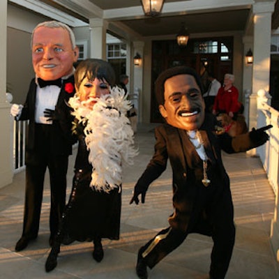 Performers in giant Frank Sinatra, Sammy Davis Jr., and Liza Minelli heads greeted guests as they entered and posed for photos.