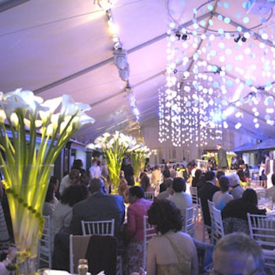 Giant chandeliers, colorful lighting, and tall centerpieces of calla lilies contributed to the whimsical ambience in the main tent, where dinner was served.