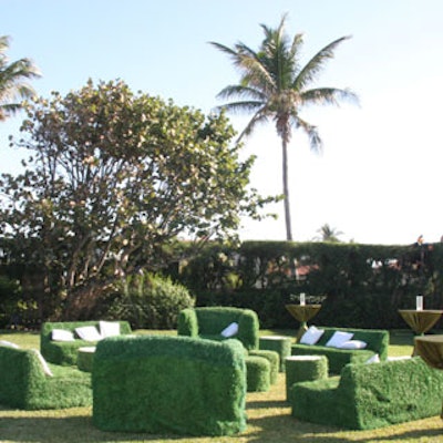 Furniture slip-covered in a synthetic grass fabric made for an unusual juxtaposition on the property's lawn.