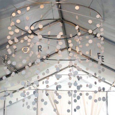 An installation of hanging circles and silver letters that spelled out the benefit's name embellished the two oversize chandeliers.