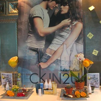 IN2U products adorned a table in front of a large IN2U poster at Lot 332 for Coty Canada's launch of the new Calvin Klein brand in Canada.