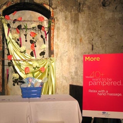 A bamboo trellis with satin fabric and abstract blooms decorated the Schick Intuition hand massage station.