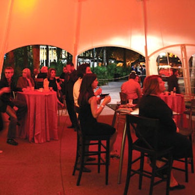 Guests relaxed in a tent provided by Top Tent that was decorated in shades of red, black, and silver. Kirby supplied the linens.