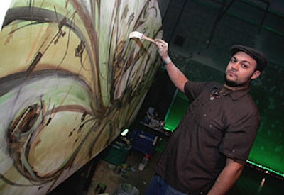 Graffiti artist Kofie used nontoxic paint to create an abstract piece inspired by the event’s tan, white, and green color scheme.