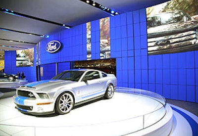 It was hard to miss the 110-foot-long, curvilinear video wall of LED and painted wood panels that dominated one side of Ford’s booth, and its sporty Interceptor concept model. For a more finished look, Exhibit Works covered the ceiling of the booths with a scrim.