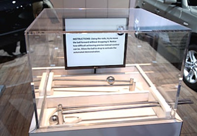 The interactive gadgets—levers, bouncing Ping-Pong balls, and a ball-bearing puzzle toy—on display at BMW’s booth promoted new technology and products like stabilization controls and tires that operate safely when punctured