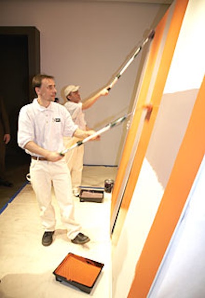 Painters hired for the event covered darker shades with light colors to show the paint´s ability to cover bold colors smoothly in one or two coats.