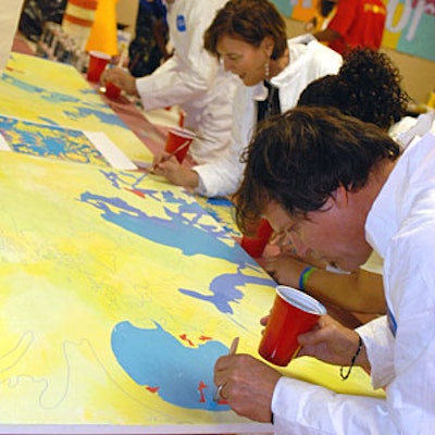 All attendees at the event could put white jumpsuits on over their party clothes and paint tabletops alongside school children. Publicolor later auctioned the tables off; one fetched more than $3,000.