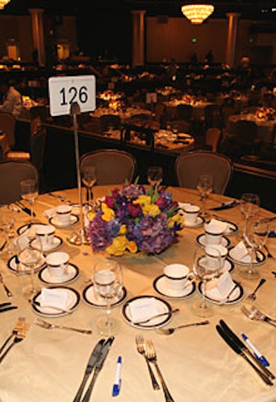 Flower arrangements reminiscent of L.A. Lakers team colors—including irises and golden roses—served as table centerpieces.