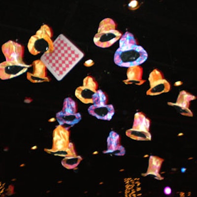 Colorful black-light top hats and oversize playing cards hung from the ceiling.