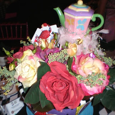 Robyn Story Designs provided whimsical centerpieces that consisted of flowers, teapots, and playing cards arranged in colorful bowls.