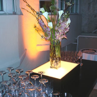 A simple floral arrangement was displayed atop a light box behind each of the two bars.