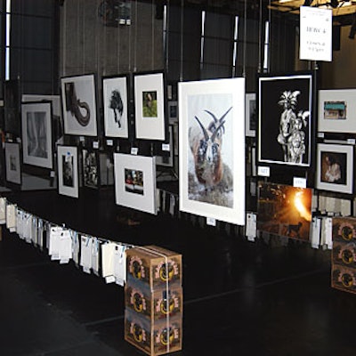 Toma Fichter of the Metropolitan Museum of Art suspended photographs on wires throughout the space. Strung from a clothesline, the bidding sheets sat beneath the items up for auction.