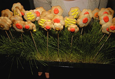 Dessert included a last-minute addition to the menu—mini chocolate and vanilla cookie lollipops. Shaped like sunflowers, the cookies, which had a pastel yellow, green, or peach center, sat on skewers and rested in beds of wheat grass.