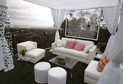 To bring out the country club theme, Caravents used a pink and green palette for the seersucker pillows and banana-leaf-patterned throws on the white poolside chaises and couches in cabana areas.