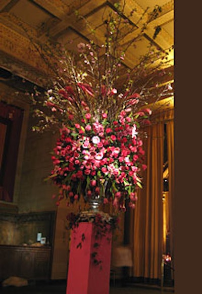 A profusion of spring blooms, including tulips, roses, and cherry blossoms, towered over attendees in the cocktail reception area.