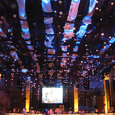 The main decor feature was an nstallation—long strips of satin and organza fabric interwoven into a lattice—that covered the ceiling of the former bank with a loose canopy.