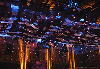 Suspended from the canopy, strands of Styrofoam spheres in different sizes hung over the dinner area.