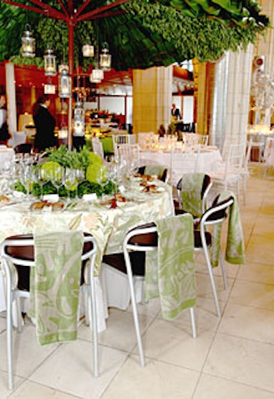 A fanciful leaf-covered umbrella dominated the summery table by Studio Sweet Pea. Little lanterns hung over the table from the leafy structure, and the backs of chairs got special treatment, too: foliage-patterned beach towels.