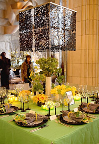 DeJuan Stroud played with color and pattern, using solid acid green on the table and alternating napkins in black-and-white houndstooth and citrus-colored polka dots. A lamp with a cubelike filigreed flower-motif shade rose out of the center of the setting.