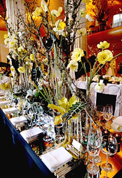 LMD Floral Events Interiors lined the banquet table with unique botanic specimens like black sea fans and branches covered in lichen and used a mirrored top to create an aquariumlike, watery effect.