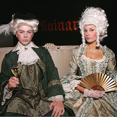 Actors playing French nobility sipped vintage Dom Ruinart Champagne while seated atop an 18th-century settee upholstered in silk at the Los Angeles launch of Dom Ruinart.