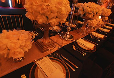 Diners found tabletops set with roses bursting from gold urns, chargers trimmed in gold, and menus in a Gothic font backed with black suede.