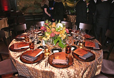 Bronze chargers and cloths topped dinner tables.