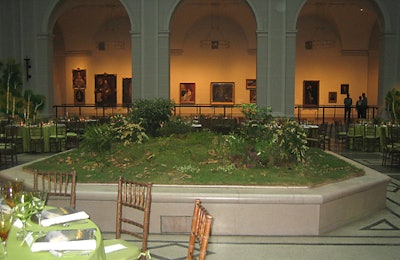 The pair worked with Shannon Florist to decorate an octagonal platform in the middle of the room with a small pond (created from a kiddie pool), moss, and leafy plants to create a woodsy display inspired by Durand’s works.