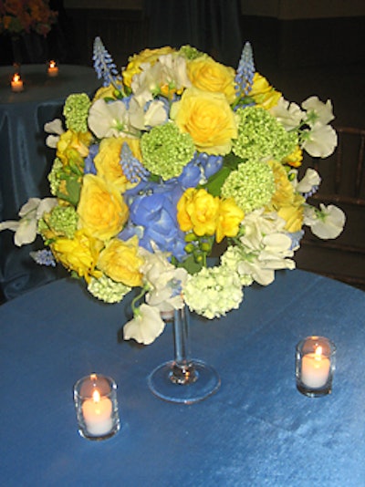 Instead of traditional floral centerpieces in a vase, the duo arranged mosses, ferns, orchids, and branches directly on the tables.