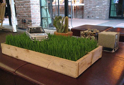 The understated Land Rover lounge referenced the brand with a model SUV propped in a wheatgrass centerpiece.