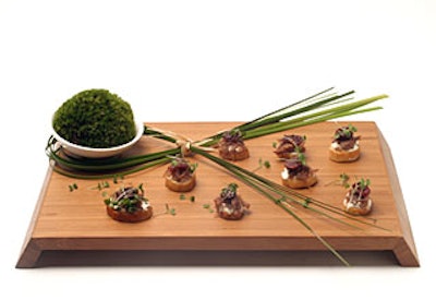 Catering from Great Performances employed organic produce, food from sustainable farms, acacia wood, and bamboo trays, as well as decorative touches of moss, leaves, orchids, and ginger.