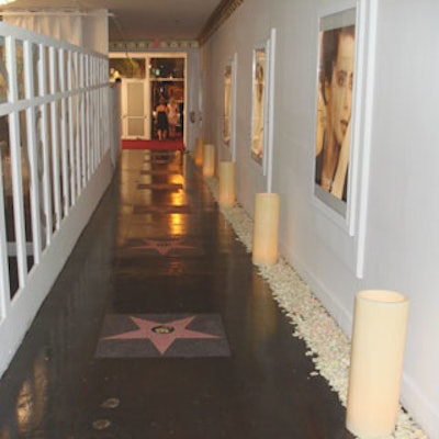 Large candles and white rose petals added to the decor in the entrance corridor, as did shots from several L'Oreal print ad campaigns.