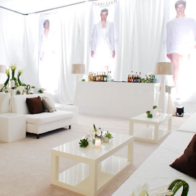 A simplistic white lounge with three hanging banners and several shaped orchids defined Perry Ellis' role this night.