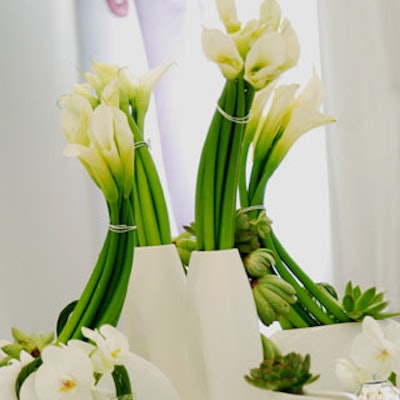 Bunched floral arrangements swooped out of porcelain vases.