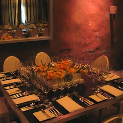 Bright spring bloom centerpieces jazzed up smaller black square dinner tables with white Ghost chairs.