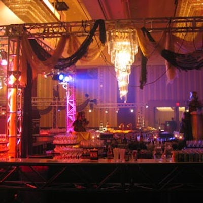 Tattered dark coloured fabrics and Elvis Prestley busts embellished a massive truss in the centre of the room that served as the main bar.