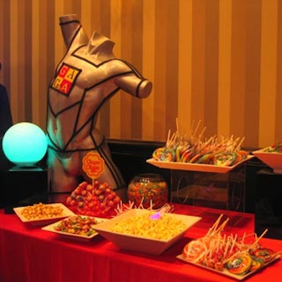 Candy stations decorated with torsos and glowing spheres served lollypops and popcorn.