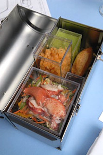 Inside the silver lunch boxes, guests found lobster and chop-chop salad, minted pea soup, crunchy won tons, and Asian sesame dressing in smaller plastic boxes to mix and match.